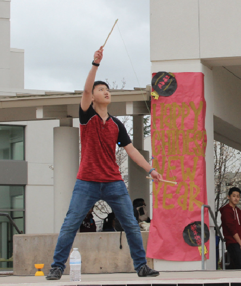 Sophomore Raymond Wang performs with a Chinese yo-yo at the celebration during lunch. 