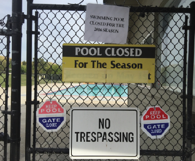 Sign outside San Ramon Golf Club swimming pool indicating the indefinite closure of the pool. The Aquabears swim team has relocated to the Dougherty Valley Aquatic Center.