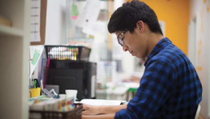 Sophomore John Ty works diligently as he grades papers as a part time job at the Eye Level Learning Center. He hopes to continue this job in the summer.