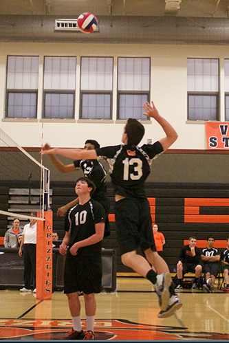 Senior Garret Meyer (13) goes for the spike in a May game.