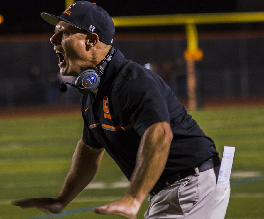 Varsity football coach Eric Billeci shouts instructions to his team during last week’s game.