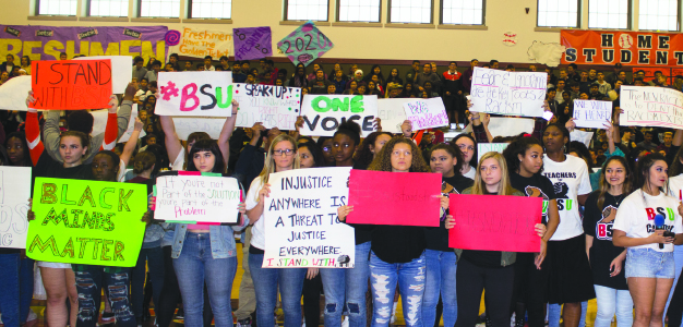 Cal students stand with members of the Black Student Union during the homecoming rally in protest of the recent racism that has appeared in the form of graffiti in bathrooms on campus. 