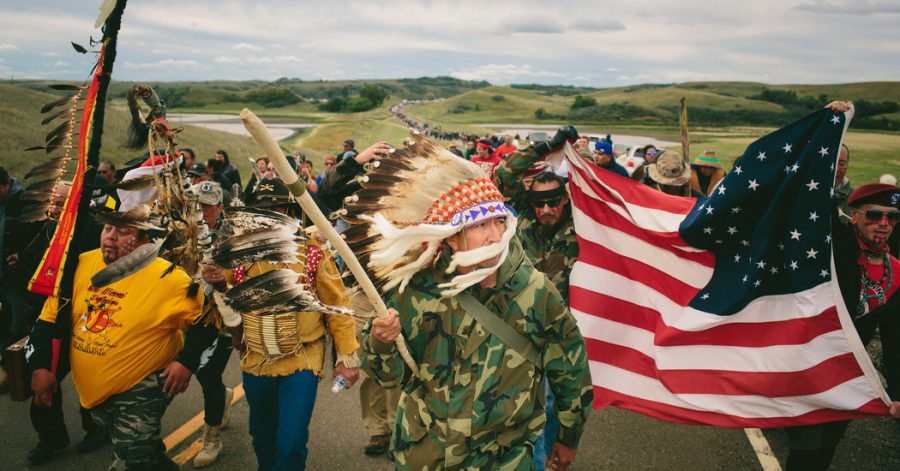 Protesters, including army veterans, join together to peacefully oppose against the construction of the Dakota Pipeline.