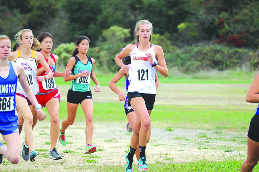 Junior Kayla Neumann, left, competes at the state championship meet in Fresno on Nov. 26.
