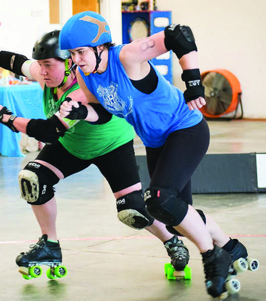 English teacher Devan Manning, right, participates in a practice for her roller derby team, the Oakland Outlaws.