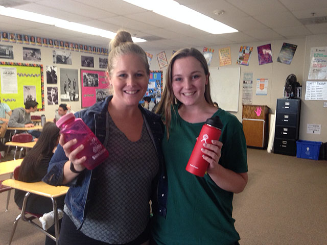 Senior Ellen Lyons, right, and Principal Sarah Cranford both pose with their water bottles, which students will be able to soon fill on campus at Flowater  reusable stations, such as the one pictured right.