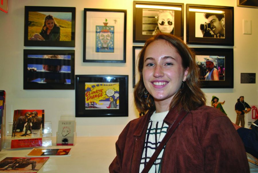 Senior Katie Kravitz displays her digital artwork at the Face It district art show.