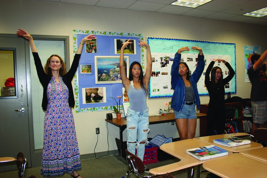 Teacher Miranda Kershaw leads French students in brief ballet lessons, where she teaches them poses along with French terms such as tendu and relevé.