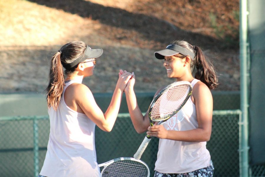 Sophomores Taylor Long, left, and Shrishti Garg celebrate in a match against Amador Valley. The duo won the EBAL Doubles Championship and qualified for NCS.