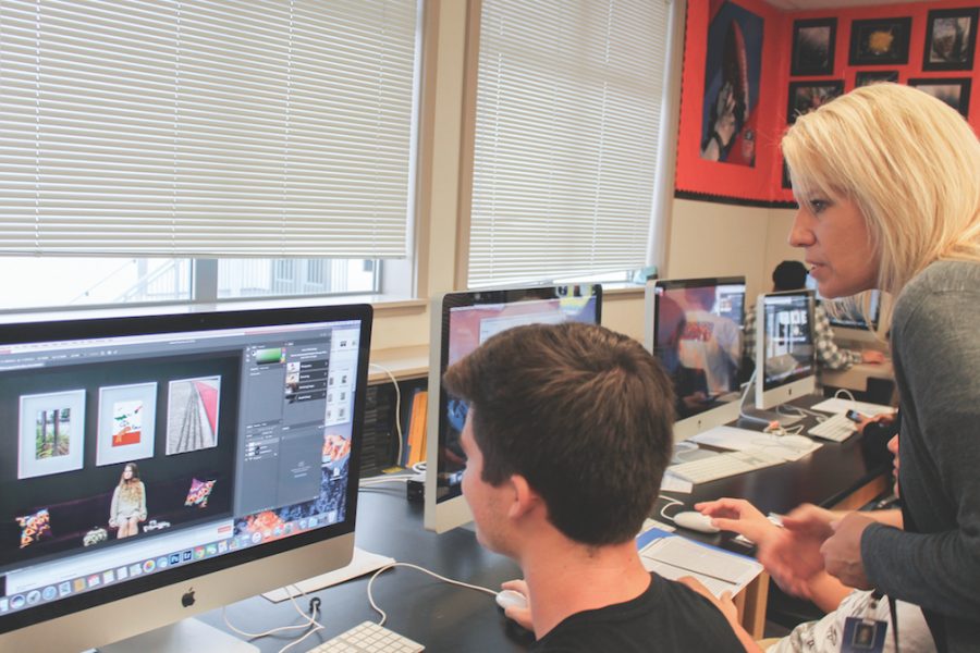 Computer graphics arts teacher Jennifer Bible helps a student operate Photoshop and work on a class project. This is her sixth year teaching at Cal High. 