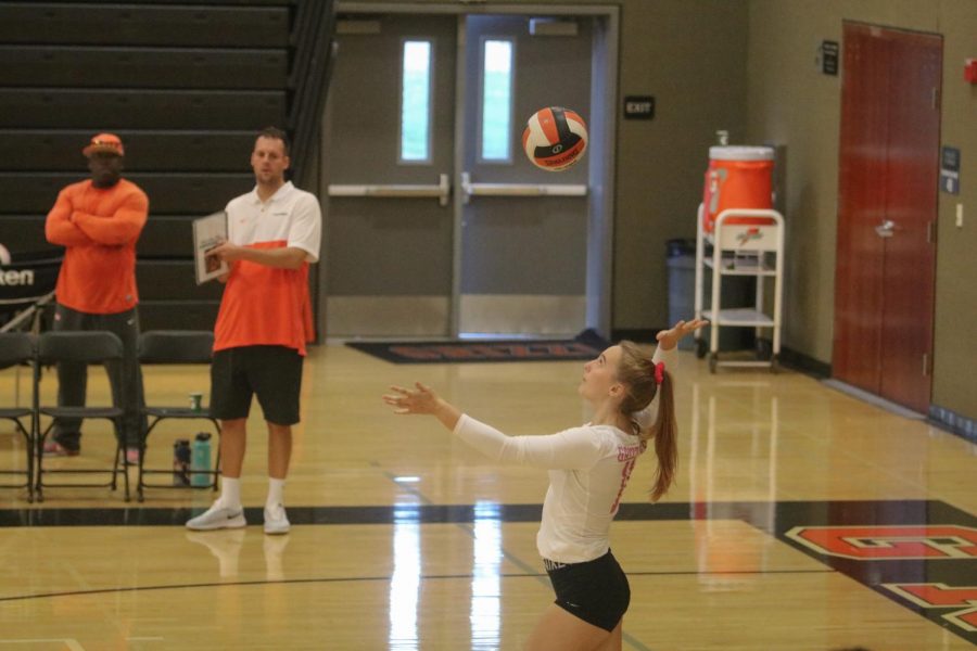 Junior McKenna Keowen prepares to serve the ball.