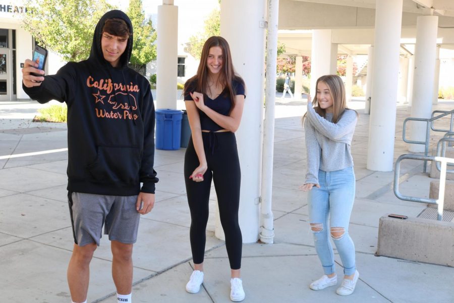 From left to right, sophomores Matt Hanson, Abbey Cullen, and Mikayla Grumley film a dance to a song on the popular app Tik Tok.