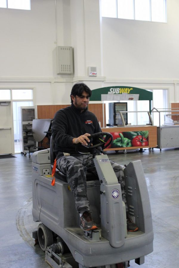 Head custodian Roberto Manrique buffs the commons floor. Manrique has been working at Cal High since 2007.