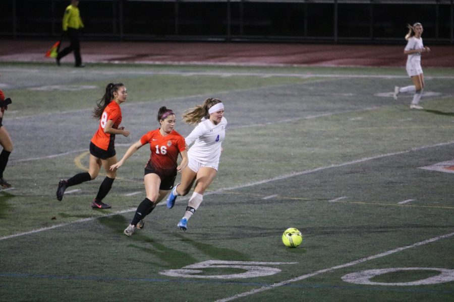 Senior forward Angela Filosa (16) races to beat Amador Valley’s Allison Jones to the ball.