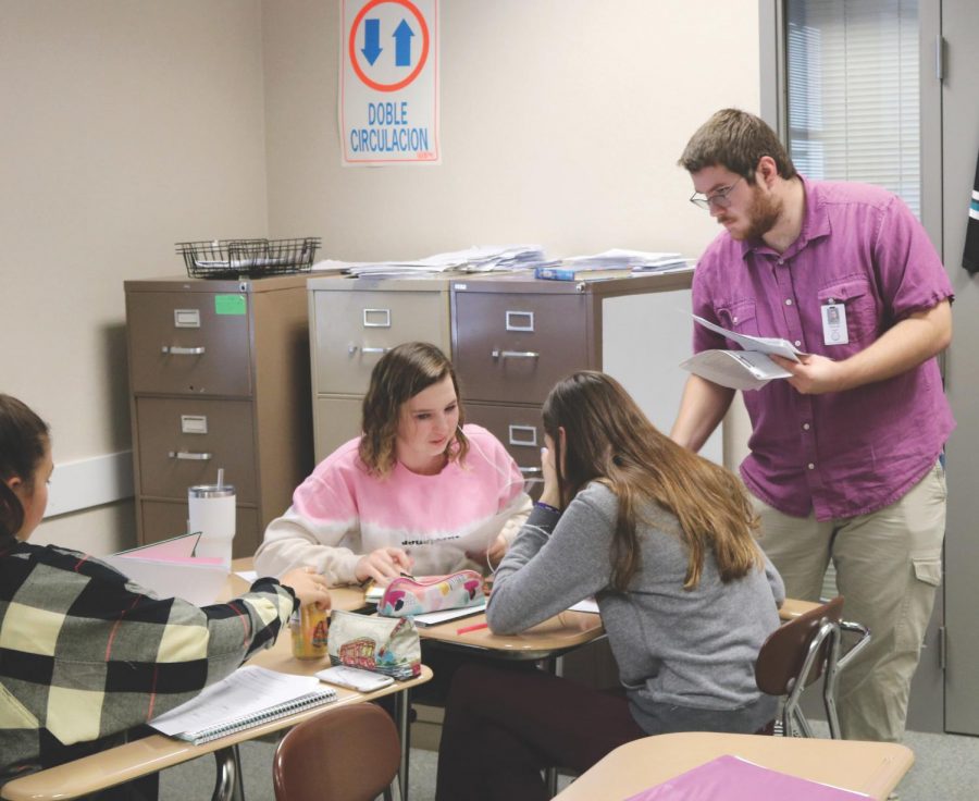 Substitute teacher Spencer Hight hands out papers to Smith’s Spanish 3 students. Hight was the class’s sub for 30 days between the first and second semesters. Students ares still waiting for their long-term sub to arrive.