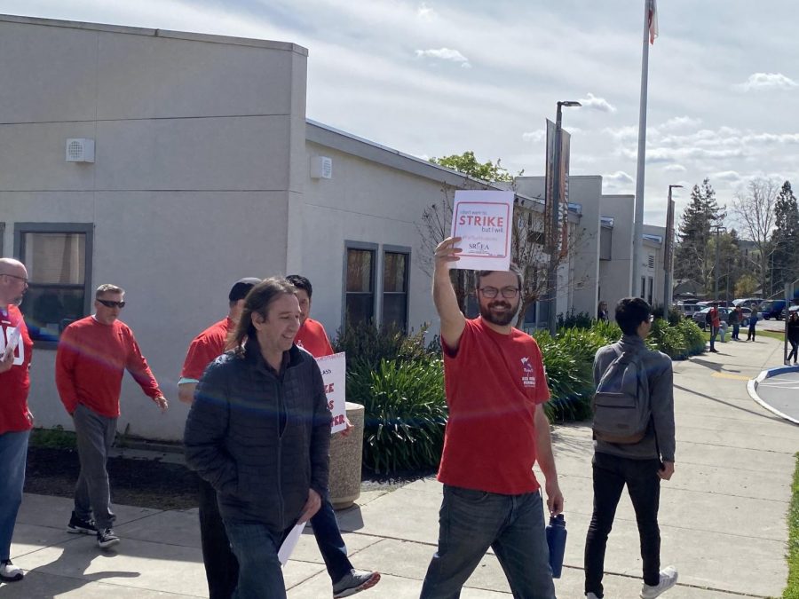 Teachers march in front of the school to communicate their hopes for improving Cal.