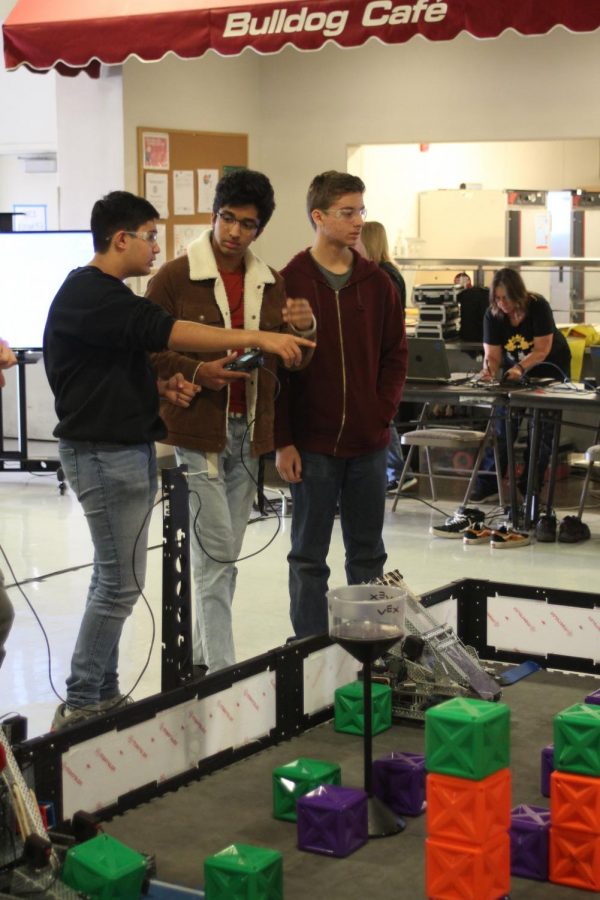 Sophomore Shaurya Srivastav, left, and seniors Shaun Bhide and Robbie Vannucchi discuss strategy before a match at a tournament in Ceres on November 23, 2019.