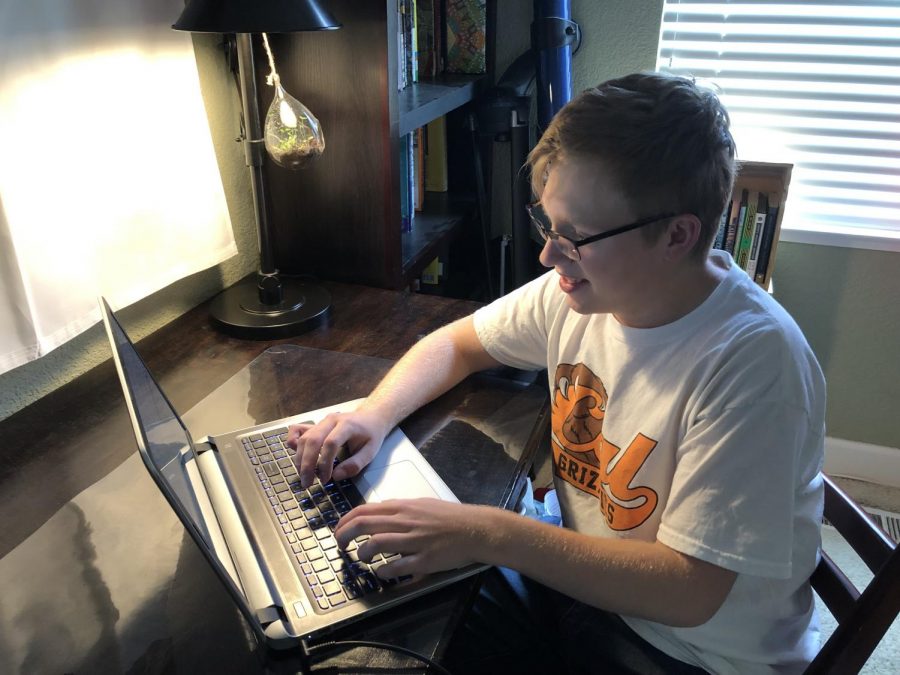 Junior Nick Harvey works at his computer from home this year while learning remotely. Although Harvey plans to return to campus next year, nearly 500 students in the district have enrolled in the new Virtual Academy and plan to continue schooling from home.