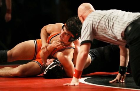 Daniel DeSoto headlocks Granada’s Ian Richardson in the NCS finals en route to winning NCS for the first tine in Cal’s history. Photo courtesy John Sachs.