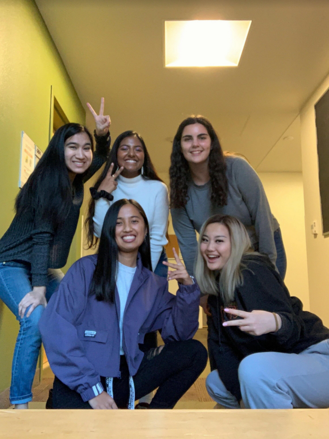 Kan (pictured on the bottom right) is posing with a group of friends at UC Davis.