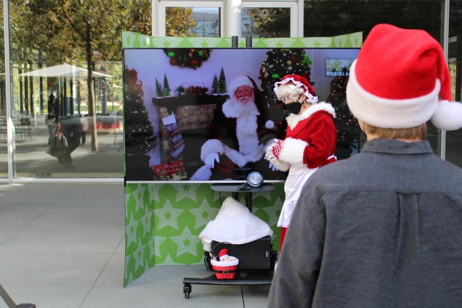 Opinions Editor Nick Harvey waits in the line to virtually meet with Santa Claus Saturday at the City Center. Kids of all ages were able to remotely engage with Santa, who appeared on a large, flatscreen TV. Mrs. Claus was there in person to help out.
