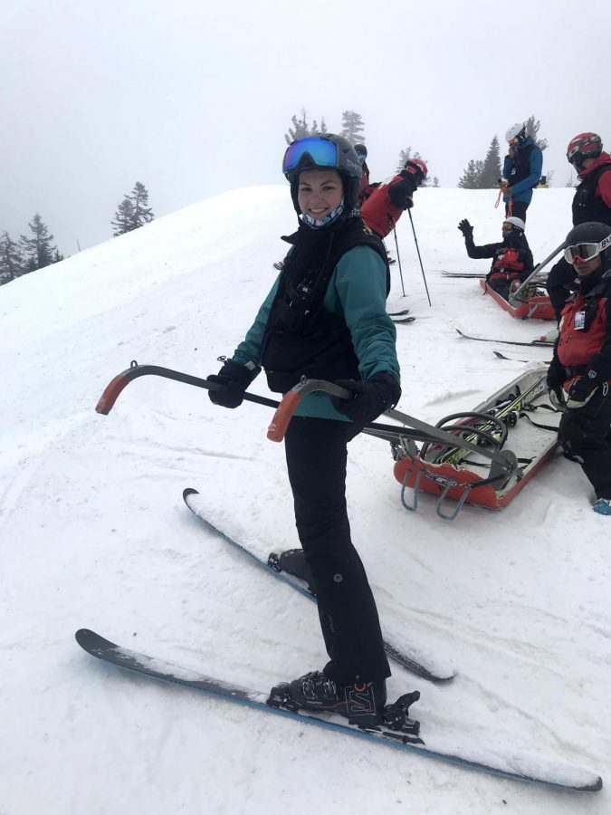 Isabela Otero stands near ski patrol equipment on the mountain at Bear Valley Ski Resort.