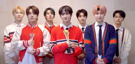 Enhyphen members from left to right: Ni-ki, Jake, Heeseung, Jungwon, Sunghoon, Sunoo, and Jay line up for a picture after winning a Top Ten Award for Top artist in the first half of 2021.