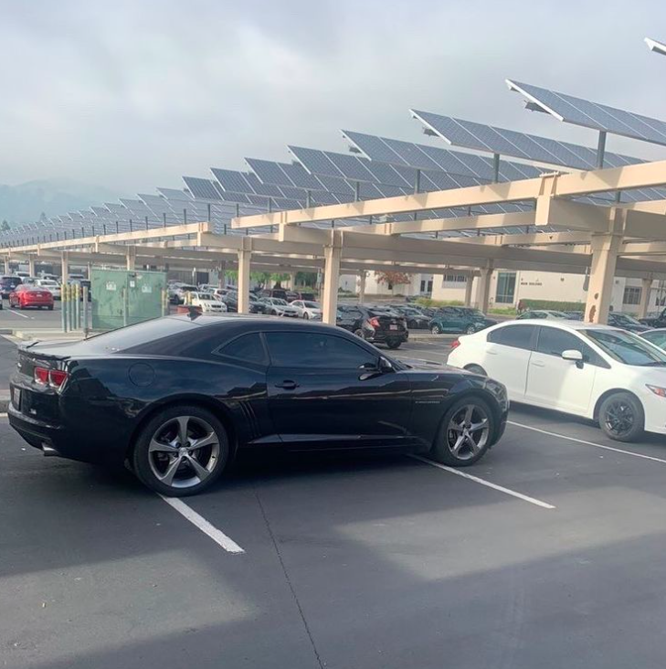 This poor parking job in the back parking lot clearly exceeds the space limitation of the standard parking space. 