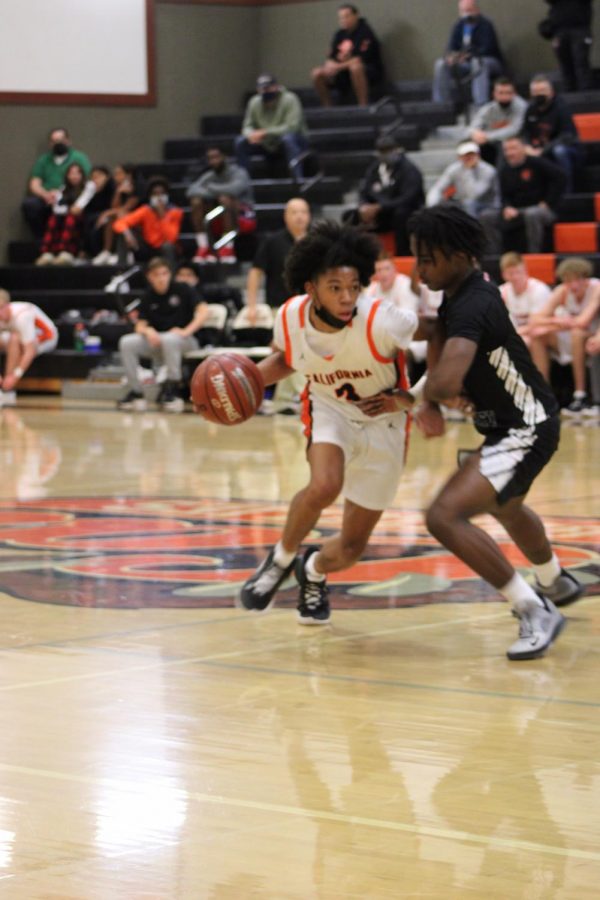 Small forward Amari Gray tries to drive around a defender for the Cal High mens basketball team. The Grizzlies are off to a hot start, going 7-3 so far and placing third last weekend at the Dublin High Tournament.