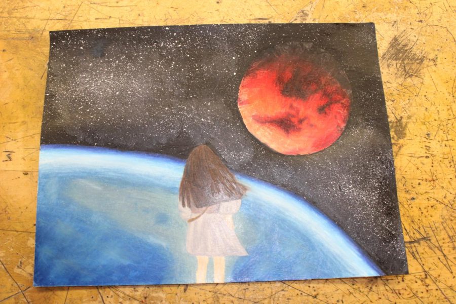 Senior Ramya Kaja’s piece from her AP Art portfolio depicts a girl on Earth staring up into space and follows her theme of exploring curiosity. All AP Art students need to create 15 pieces based on a single theme for their portfolio.
