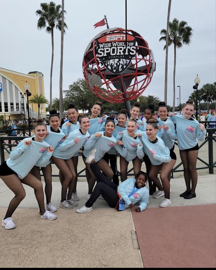 The+song+team+poses+in+front+of+the+ESPN+Wide+World+of+Sports+Complex+in+Orlando+during+their+trip+to+the+national+championships.+The+team+placed+ninth+in+the+pom+category.