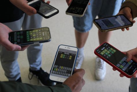 Students playing Wordle huddle around with their phones, hoping to get today’s word right.