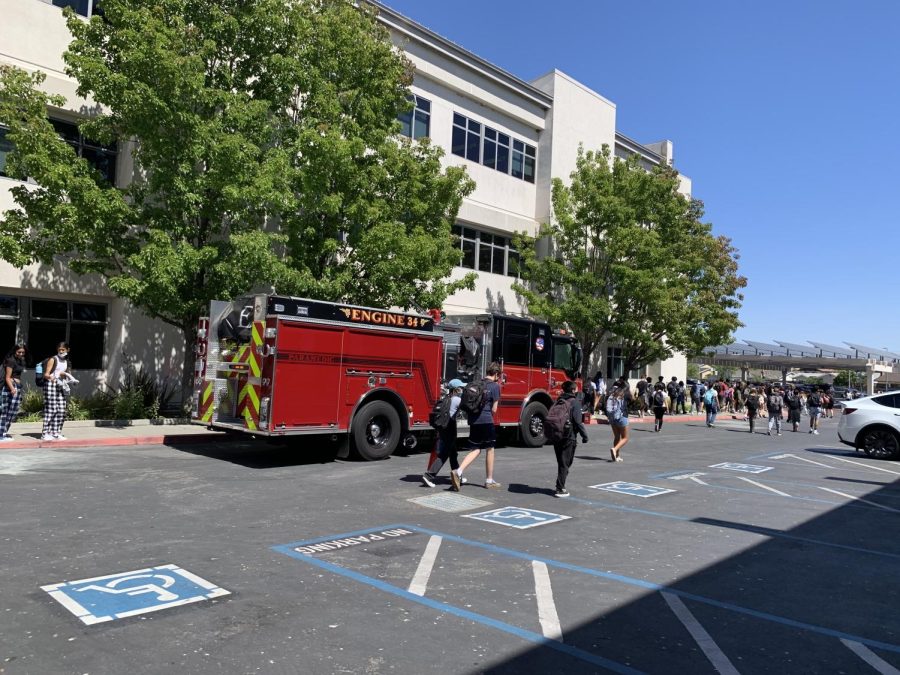 Firefighters and police investigate the scene last Friday after the fire was put out by history teacher Daniel Sweetnam. 