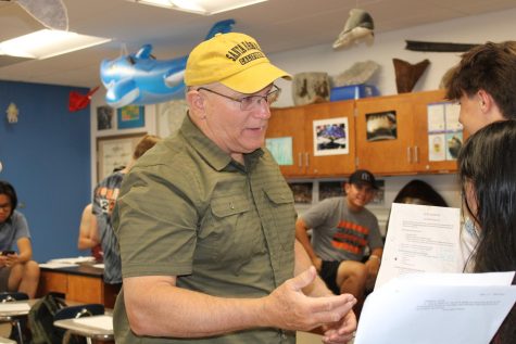 Douglas Mason talks to students dissecting a squid in the third period marine biology class. He is retiring after teaching at Cal High for 22 years.