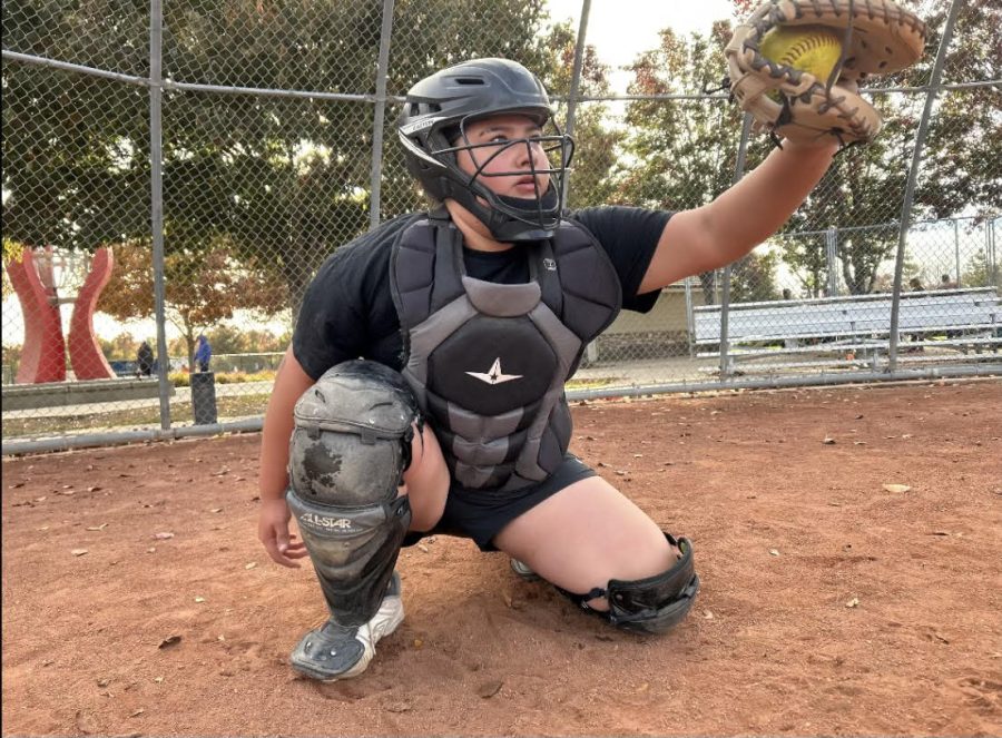 Sophomore Pi Stephenson catches a softball. Stephenson started a foundation to sponsor girls who can’t afford to purchase the expensive gear needed to play the sport. 