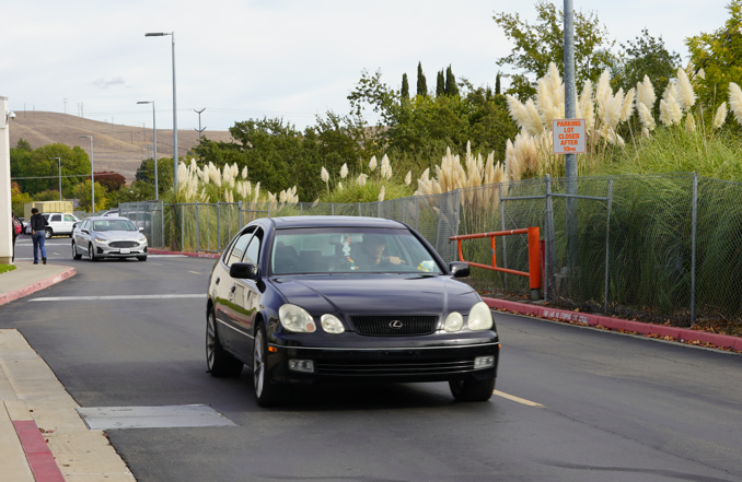 A+Cal+High+student+exits+the+back+parking+lot+in+their+car+onto+the+traffic+route.