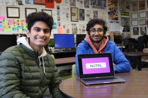 Mihir Arya, left, and Rishabh Jhamnani show off their Nütrl app logo on a Macbook.
