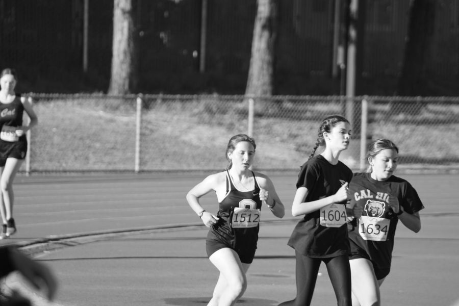 Grace Dalmada (1604) and Jenna Lightner (1634) lead the pack in this race last year for Cals track team. The team will make cuts for the first time this season.