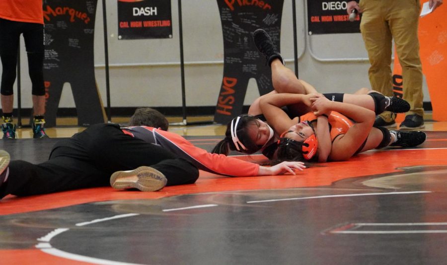 Junior Mia Larson (right) tries to escape her opponent's grasp during Cal High's senior night.