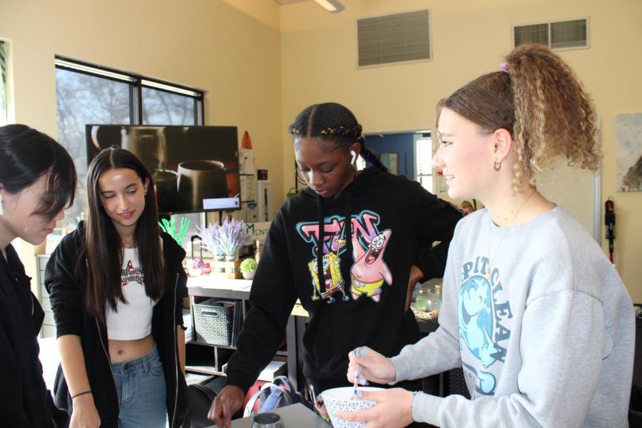 Briana Farias, right, makes therapy putty with students during her internship at Cal High’s wellness center.