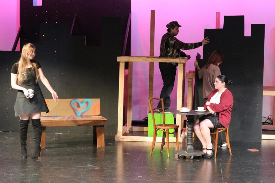 Kit Town, left,  rehearses her scene with Emma Kollo, sitting, while Shea Daly, background left, and Sarah Haslim create the set for the play “The Cassettes of San Francisco.” The play will be performed today and Friday at 7 p.m. in the theater.