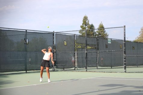 Sophomore Gracie Barco serves the ball during a varsity women’s tennis match last season.
