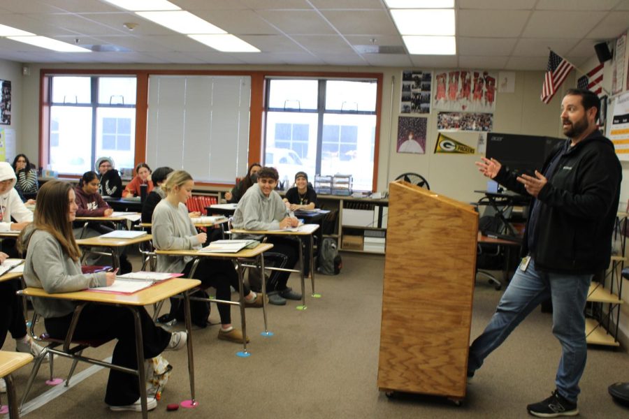 Teacher Alex Geller talks about the Generation Citizen project to his government class.