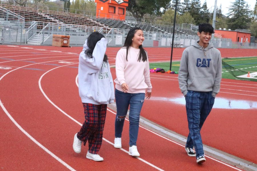 American Cancer Society president senior Brianna Marbella, left, and American Cancer Society secretary senior Veer Pudupak prepare for Relay for Life on the football track.