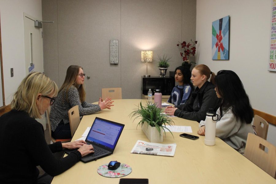 Junior Brooke Johnson is interviewed by three seniors to get into iQuest. Advisor Michelle Turner is present with a laptop