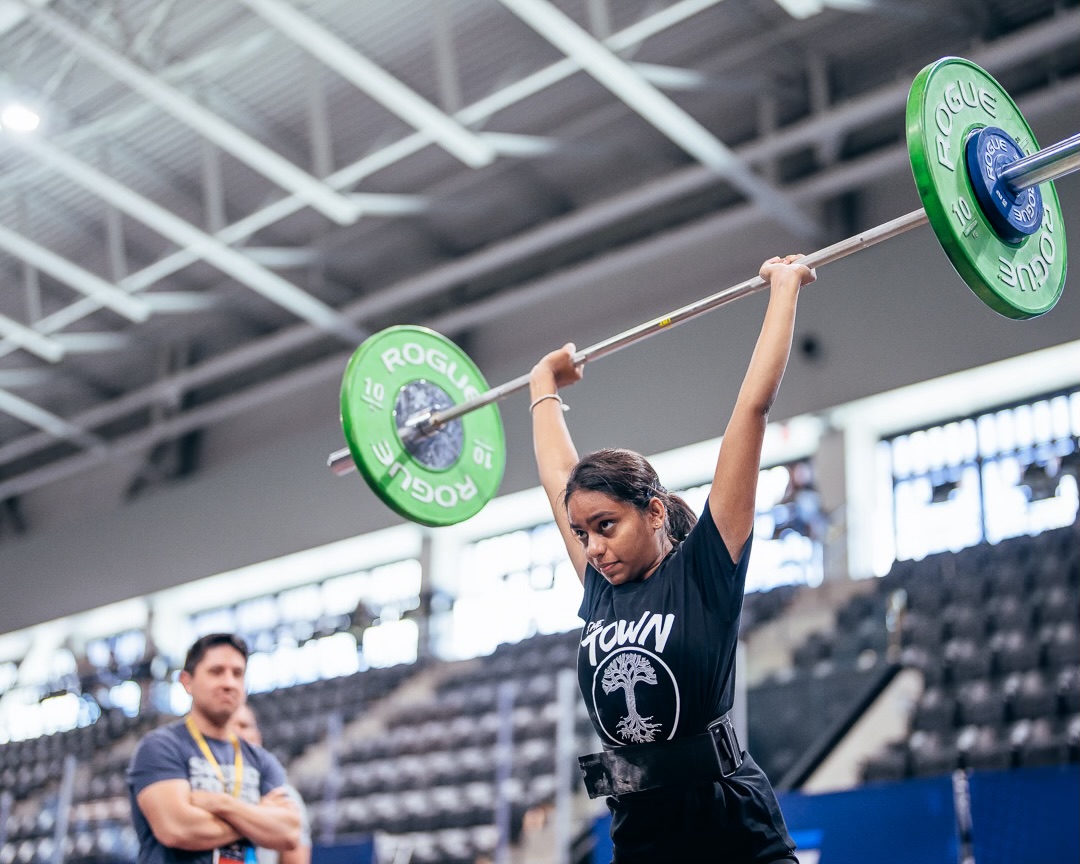 Senior Dihini Withana preforms a split-stance snatch at the Youth World Weight Lifting competition in Albania in March 2023. This was Withana’s first international competition.