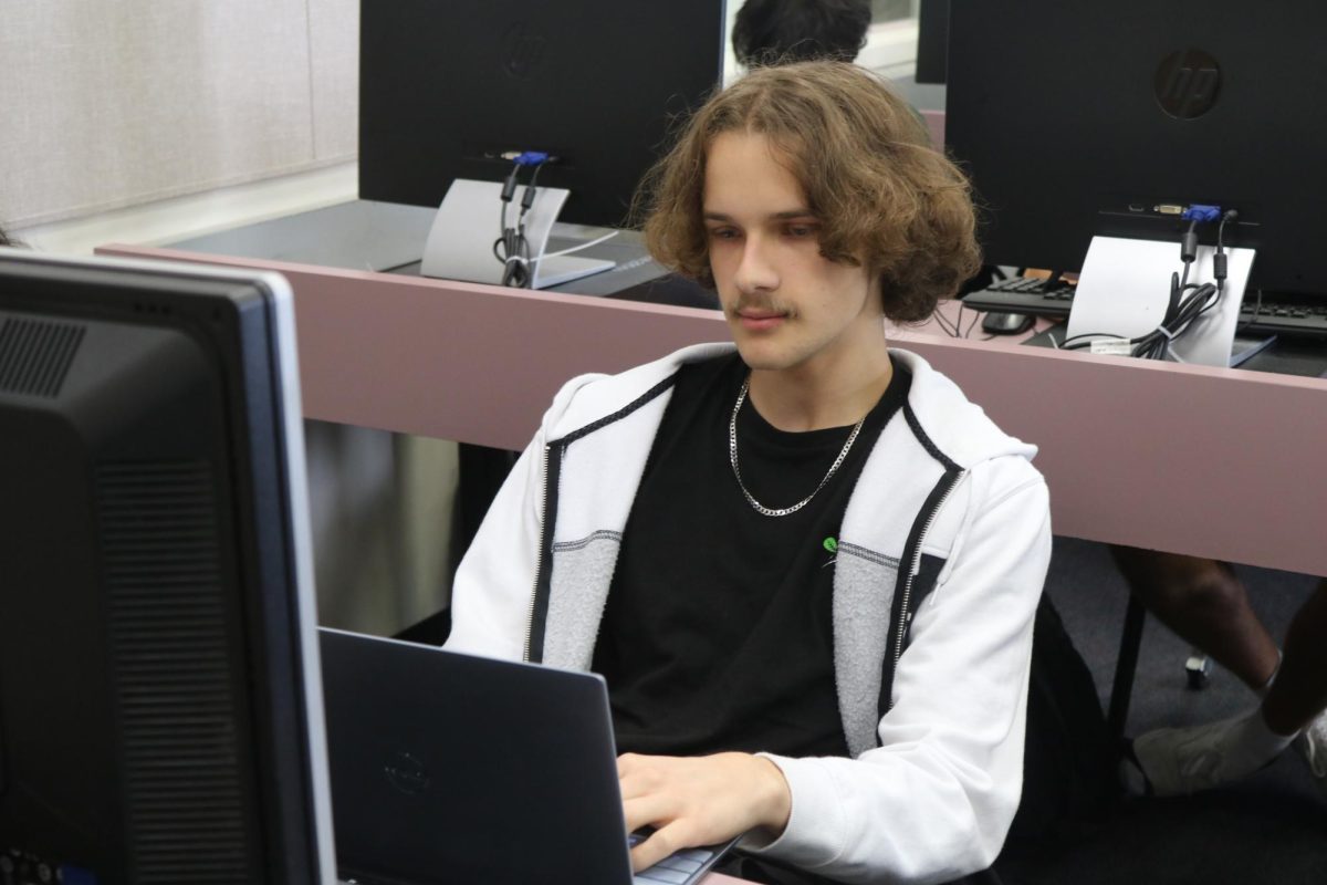 Senior Dennis Zax works on a computer in class. Zax launched a machine learning start-up company this summer called ezML.io and now has eight employees working for him.