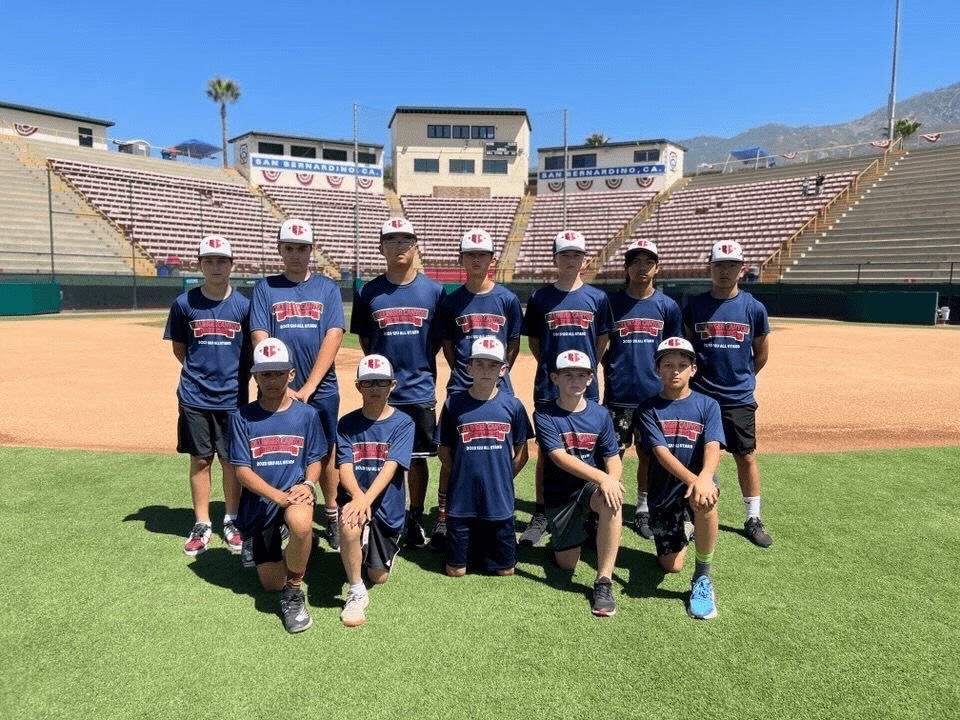 The 2023 Bollinger Canyon Little League 12U team poses for a picture in the stadium.
