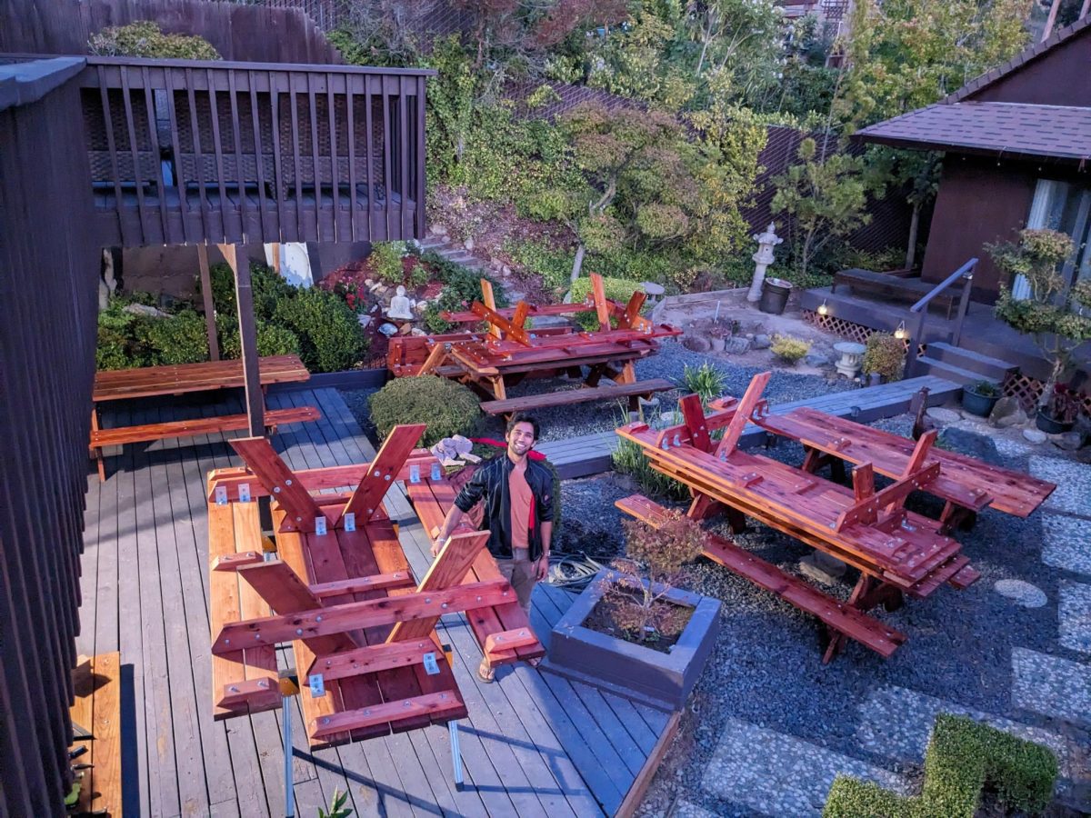 Cal High junior Ved Joshi stands in his backyard next to the picnic tables he constructed for his Boy Scouts Eagle project.