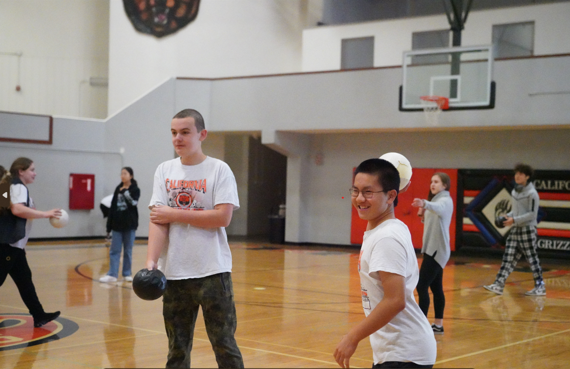 Scotty, left, and Austin prepare to throw dodgeballs at opponents in their Strategies of Recreational PE class.